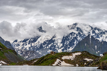 Swiss alps water reflection in Lac de Louvie - mountain lake above Val de Bagnes valley, Switzerland.
