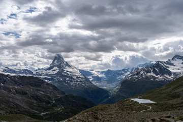 Obraz premium Scenic view of Matterhorn (Monte Cervino, Mont Cervin) mountain peak dramatic overcast with dark heavy clouds, Zermatt, Switzerland.