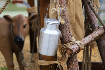 Metallic can with  cow's milk in  countryside...