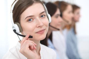 Call center. Beautiful cheerful smiling operator consulting clients with headset. Business concept of customer service