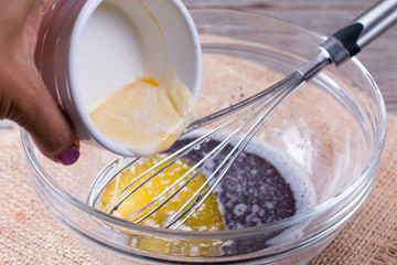 Fototapeta na wymiar Adding Melted Butter To Cake Mix
