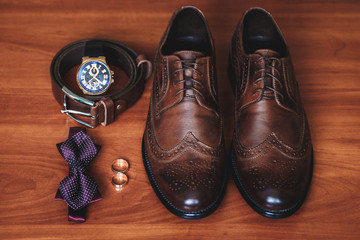 Groom accessories. Wedding details. Wedding shoes. Shoes, belt, watch, bow tie, rings.