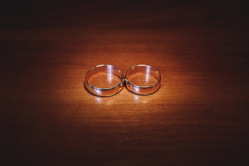 wedding rings on a wooden table