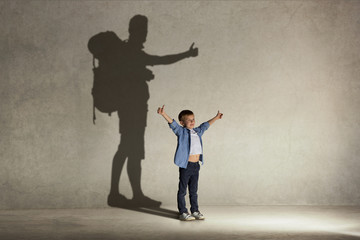 The little boy dreaming about tourism and adventure. Childhood and dream concept. Conceptual image...