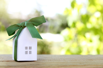 desirable gift dreams for summer stay/ layout houses, in a festive green bow on the backdrop of...