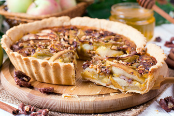 Traditional homemade apple pie with nuts and cinnamon