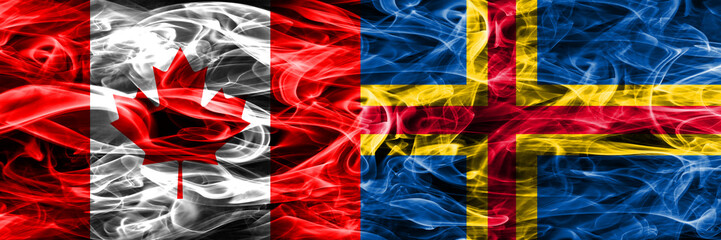 Obraz premium Canada vs Aland smoke flags placed side by side. Canadian and Aland flag together