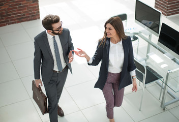 business couple discussing business issues while walking around the office