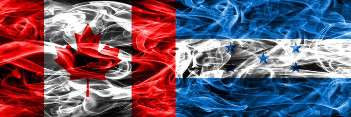 Obraz premium Canada vs Honduras smoke flags placed side by side. Canadian and Honduras flag together