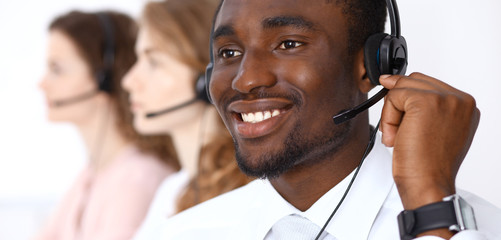 African american call operator in headset. Call center business or customer service concept