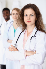 Fototapeta premium Happy doctor woman with medical staff at the hospital