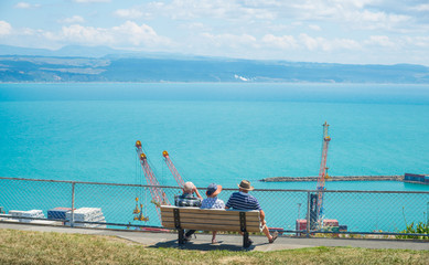 New Zealander trio elder sitting and relaxing to see the beautiful view of port of Napier from...