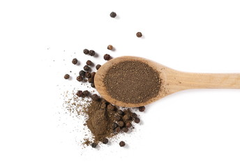 Ground black pepper powder and grains in wooden spoon, isolated on white background, top view