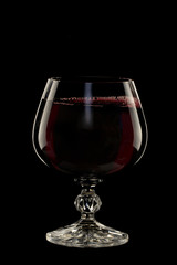 Glass still life image A glass of red wine in a glass on a black background