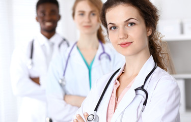 Happy doctor woman  with medical staff at the hospital