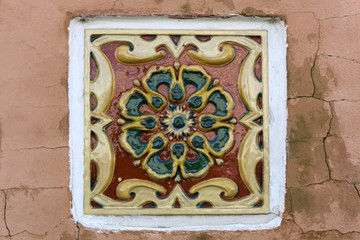 ancient ceramic patterned tile in the wall of russian building of the XVII century