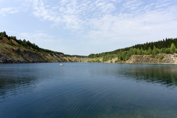 lake with blue water, a place of recreation formed on the site of old abandoned quarry..