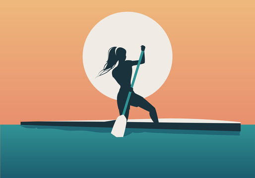 Athlete girl with hair in the wind practicing sporty rowing in a canoe