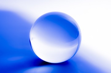 Glass ball in abstract blue