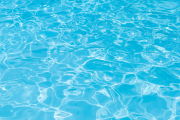 Fototapeta na wymiar Blue water in pool for background and abstract, Ripple wave with sun reflection in swimming pool, Clean and bright purified water for healthy swimming