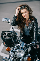 beautiful woman sitting on motorcycle with helmet