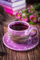Fruit tea, books and flowers asters on a wooden background