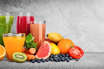 Fresh ripe healthy fruits and juices in glasses