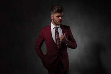 portrait of relaxed man in grena suit looking to side