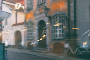 Reflection of the city in the glass of the shoe store