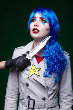 Female with knife near throat. Portrait of young woman in comic  pop art make-up style