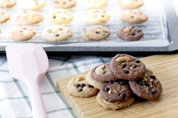 Delicious Chocolate Chip Cookies on wooden tray, Tasty Homemade cookies on wooden table, dessert with checkered tablecloth.