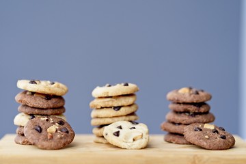 stack of Delicious Chocolate Chip Cookies, three rows of Tasty Homemade cookies on wooden table with copy space.