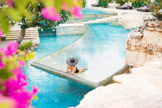 Woman in exotic swimming pool