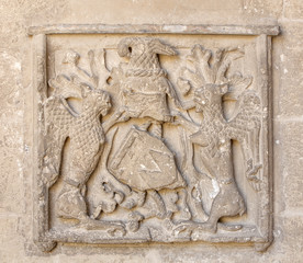 old coat of arms on the wall in the cathedral of Beziers