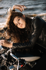 Fototapeta na wymiar attractive young woman sitting on motorbike