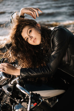 attractive young woman sitting on motorbike