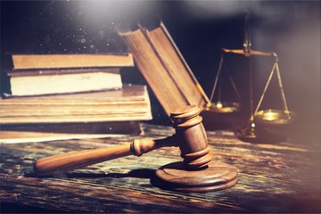 Books and wooden gavel on table. Justice