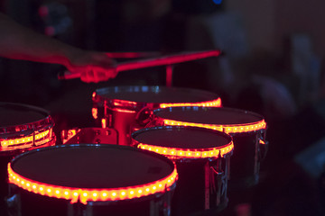 Drummer playing his drum kit on concert in club. Warning - Focus on the drum, authentic shooting...