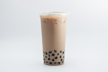 iced milk tea and bubble boba in the plastic glass on the white background 