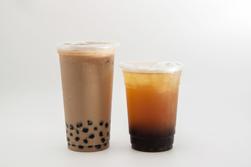 iced milk tea and bubble boba in the plastic glass on the white background 