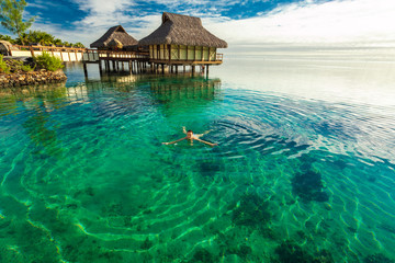 Young woman enjoying tropical beach holidays at Moorea, French Polynesia