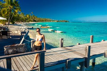 Fototapeta premium Young woman enjoying tropical beach holidays at Moorea, French Polynesia
