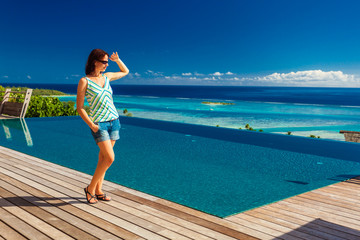 Young woman enjoying tropical beach holidays at Moorea, French Polynesia