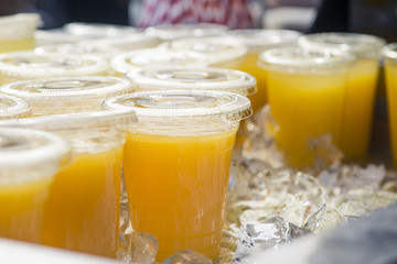 Fresh orange juice in plastic cups