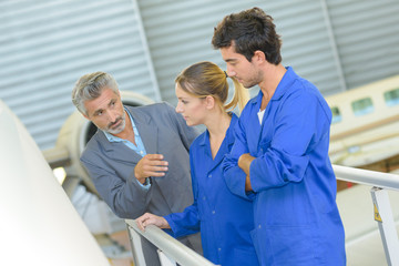 Man talking to students on aircraft platform