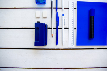 stationery pen scissors notebook on a wooden table