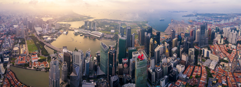 Aerial view of the Singapore landmark financial business district at sunrise scene with skyscraper and over clouds. Panorama of Singapore downtown.