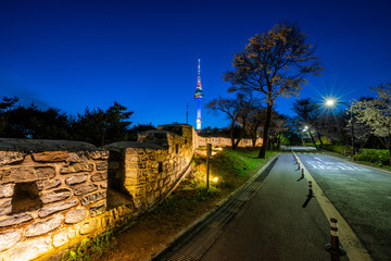 Sunset scene of light trails of car on road into N Seoul Tower at Namsan Mountain in Seoul City, South Korea.