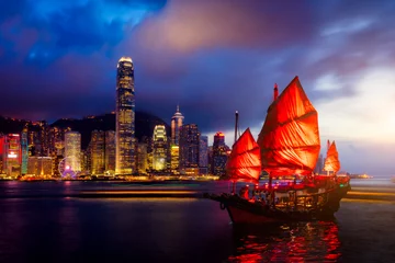 Foto op Plexiglas Hong Kong City skyline with tourist sailboat at night. View from across Victoria Harbor Hong Kong. © Travel man