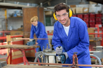 industrial worker wearing earmuffs and goggles